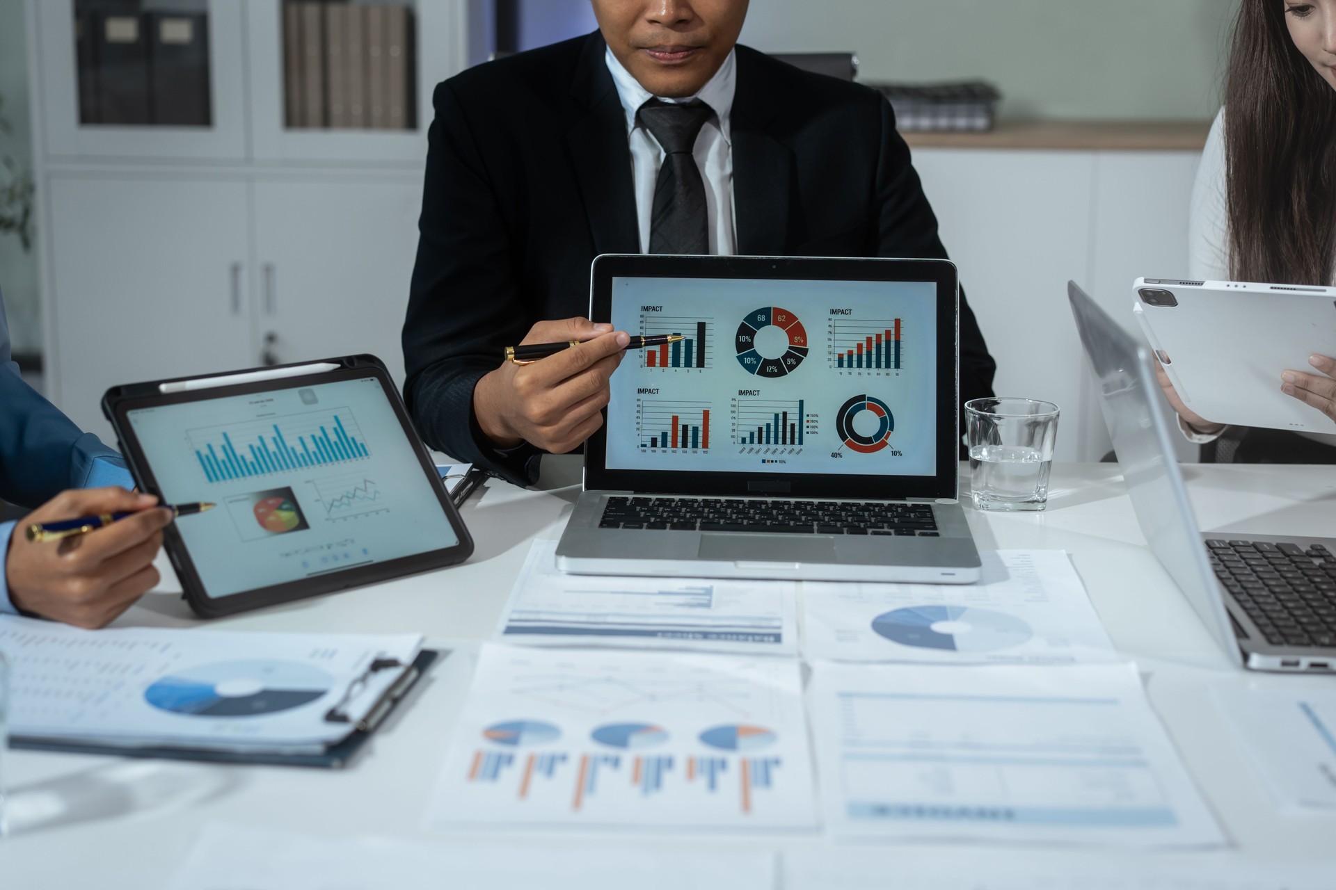 Entrepreneurs, marketers, managers, and financial analysts gather around the table to analyze data, present results, plan strategies, discuss efficiencies,grow their businesses through collaboration